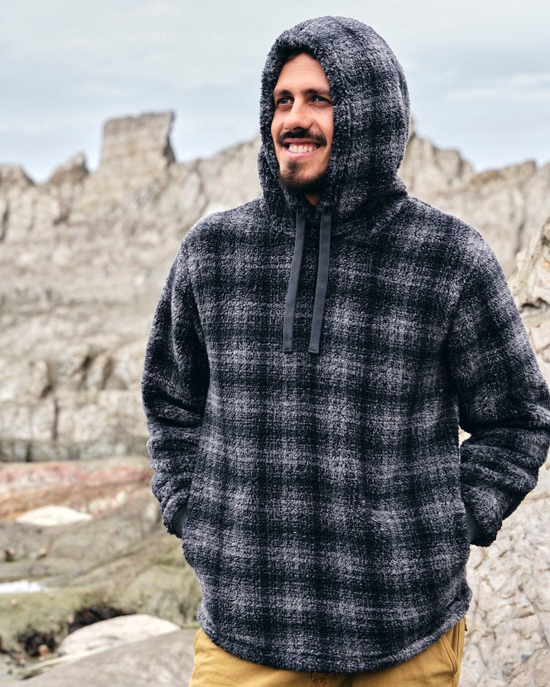 A man wearing a Saltrock Halycon - Mens Fleece Hoodie - Dark Grey.