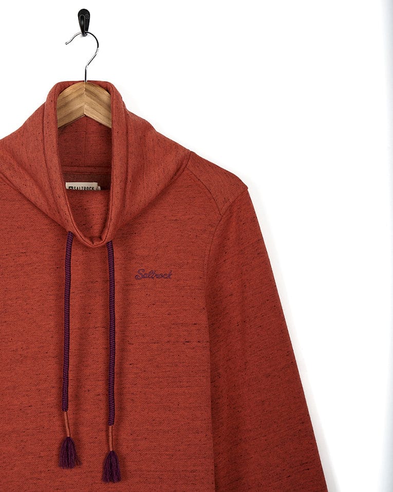 A Saltrock Harper - Womens Longline Pop - Red hoodie with purple tassels hanging on a hanger.