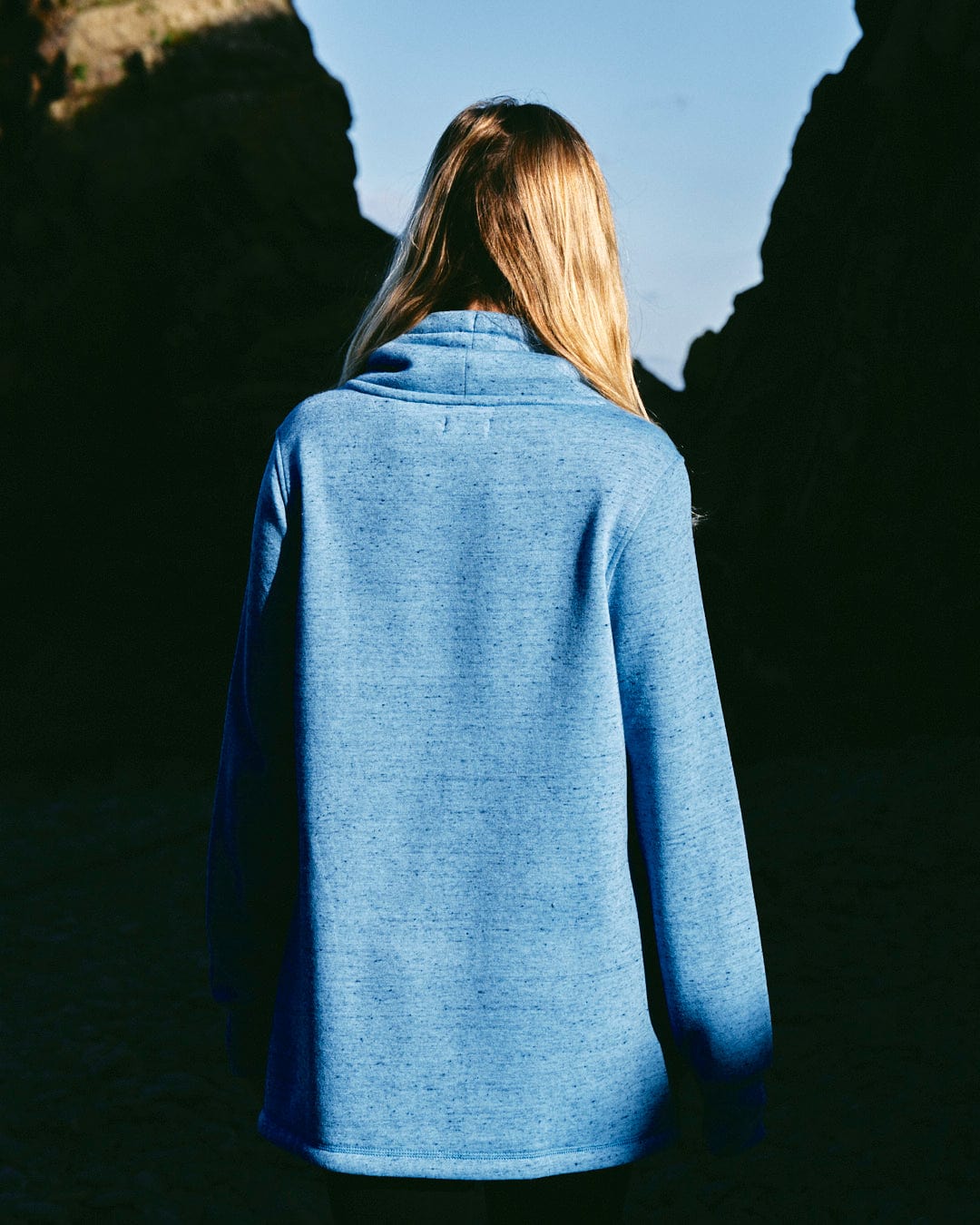 The back of a woman wearing a Saltrock Harper - Womens Longline Pop Sweat - Light Blue.