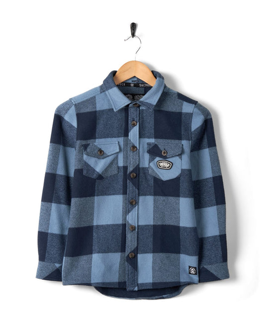 A Hawkins - Hooded Long Sleeve Check Shirt in blue with pockets on a hanger against a white background.