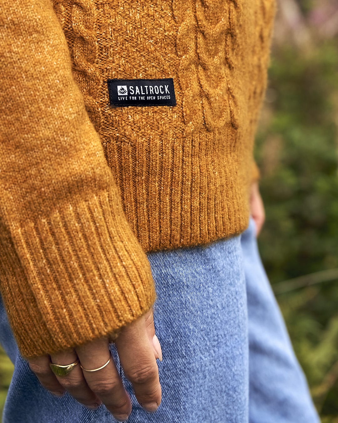A woman wearing a Saltrock Hele Bay 2 - Womens Knitted Jumper - Yellow.