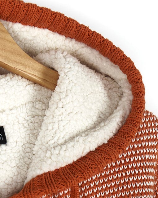 A Saltrock - Helly Womens Borg Lined Knitted Hoodie - Orange and white, hanging on a hanger.