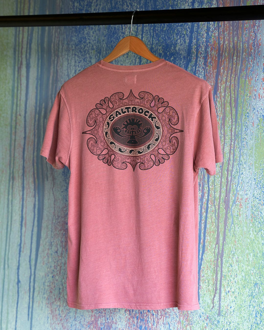 A Heraldic Tok - Limited Edition 35 Years T-Shirt by Saltrock hanging on a wall.