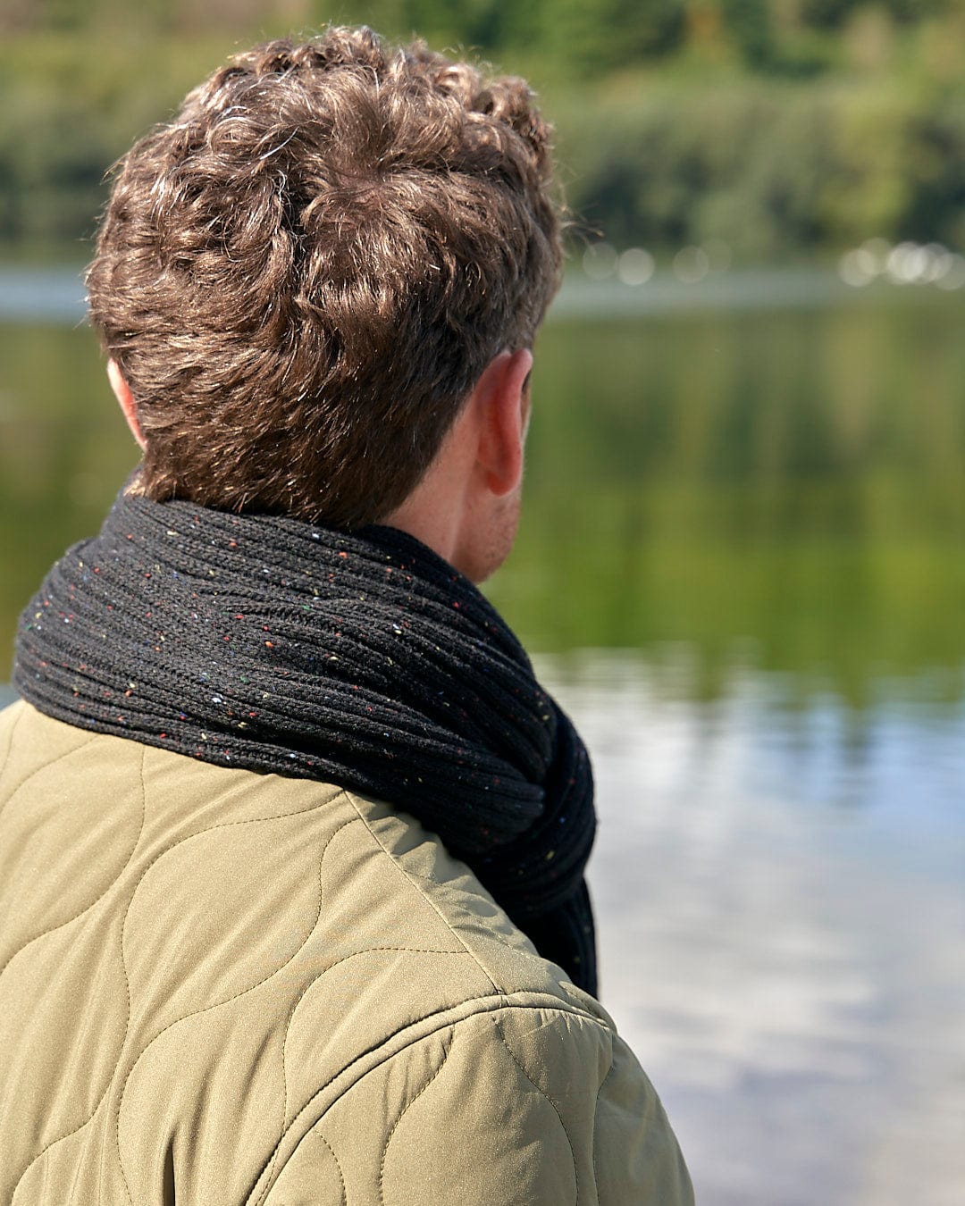 A man wearing a comfortable Saltrock Heritage - Scarf - Black jacket.