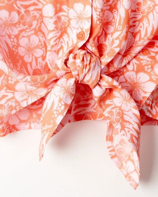 Orange hibiscus floral print Saltrock scarf tied in a knot on a white background.