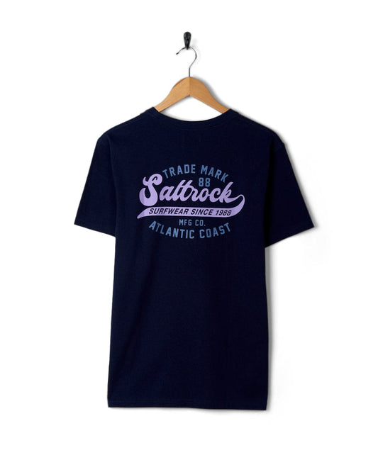 Dark blue cotton t-shirt with Saltrock logo design hanging on a hanger against a white background.