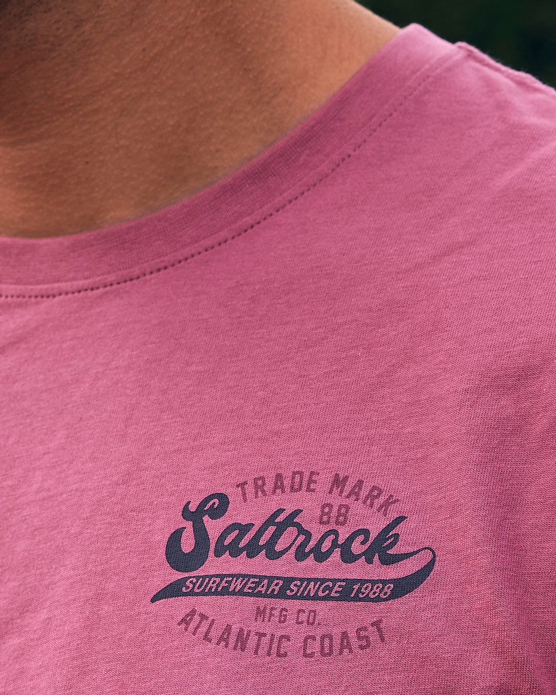 A man wearing a Saltrock Home Run - Mens Short Sleeve T-Shirt - Dark Pink.