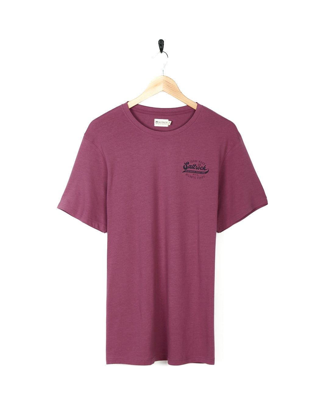 A vintage Saltrock Home Run - Mens Short Sleeve T-Shirt - Dark Pink hanging on a wooden hanger.