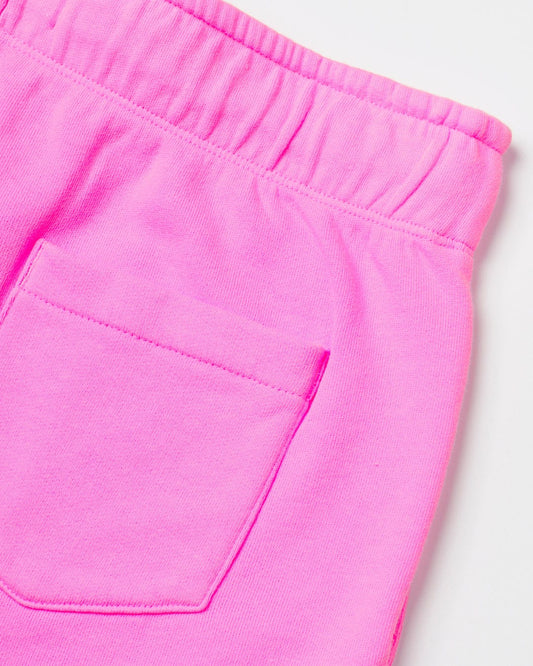Close-up of a Saltrock Instow - Kids Sweat Shorts - Pink with a visible pocket and elasticated waistband, showcasing details of the material and stitching.