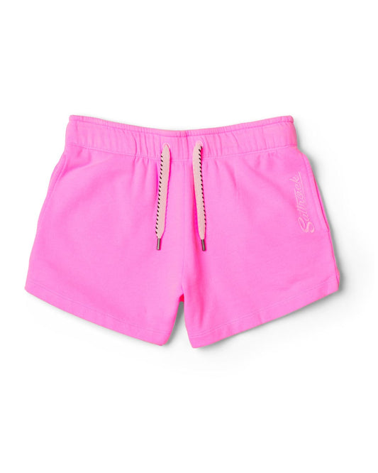 Pink Instow athletic shorts with elasticated waist and cursive lettering on the left leg, isolated on a white background by Saltrock.
