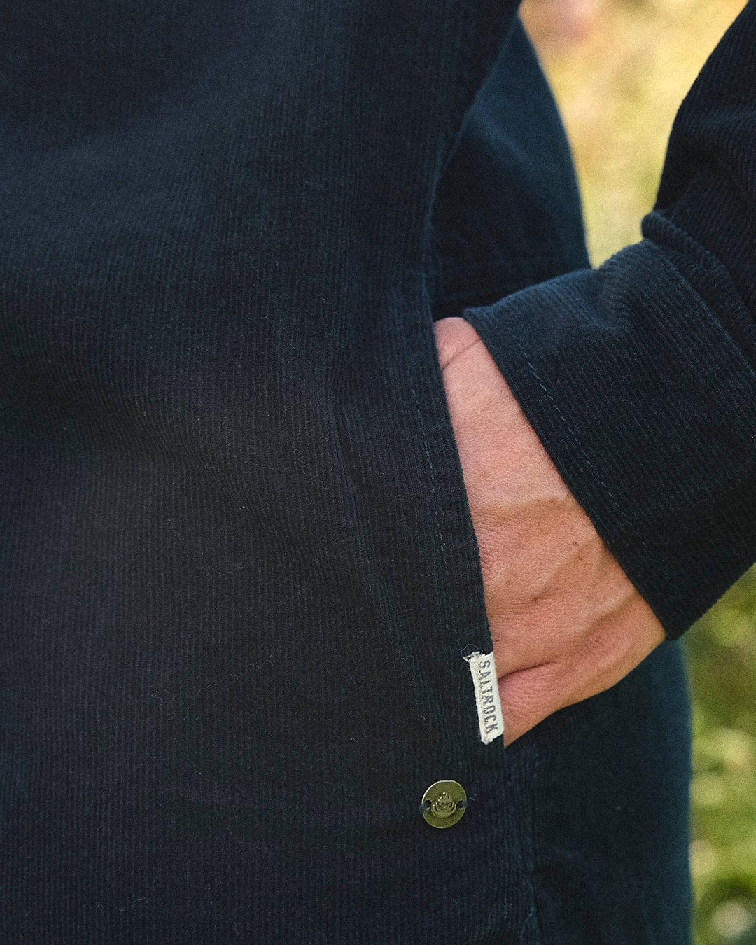 The back of a man's Saltrock Iris Cord Shirt Dress - Dark Green with a pocket on it.