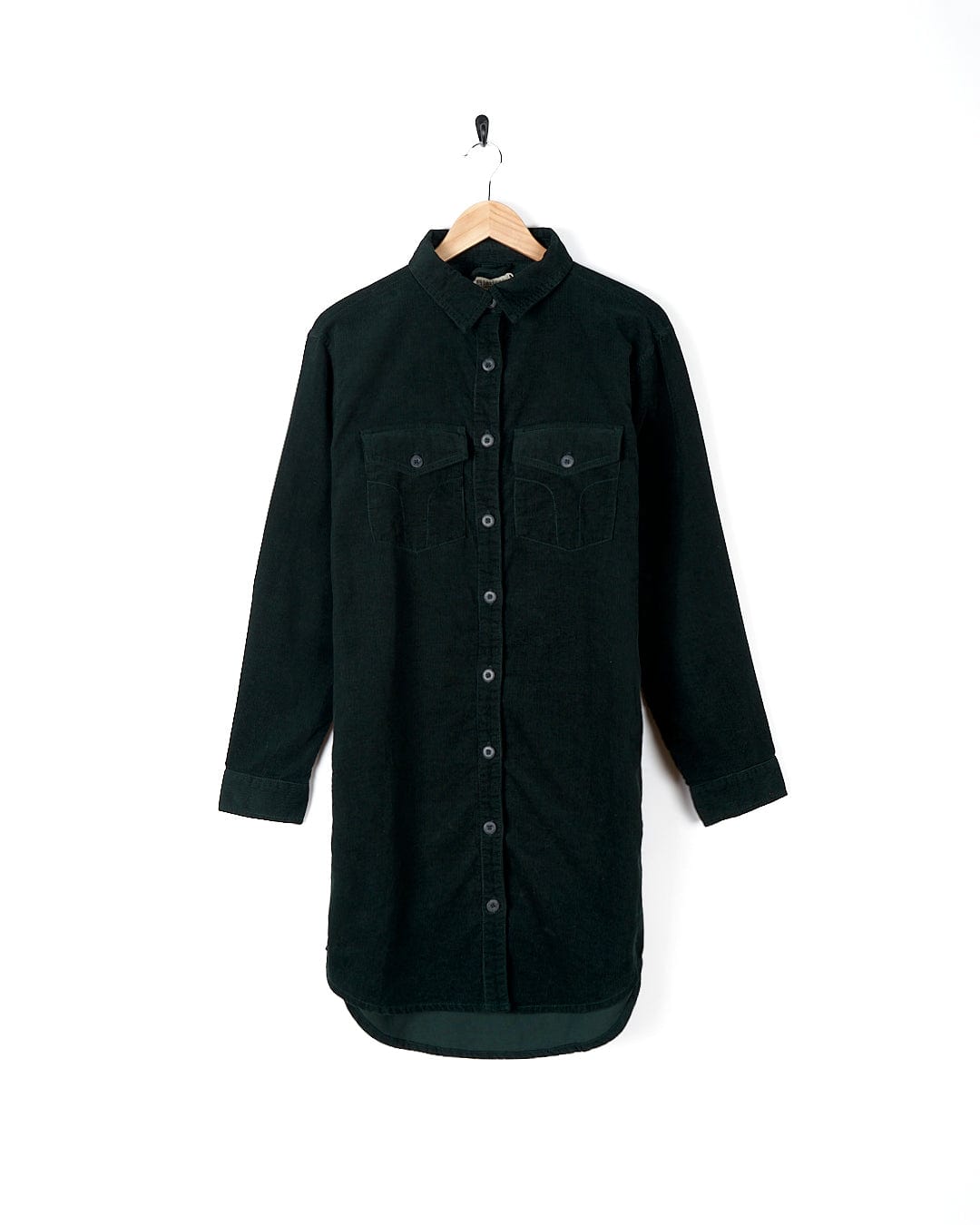 A dark green Saltrock Iris Cord Shirt Dress hanging on a hanger.