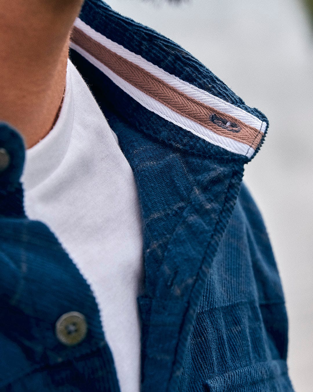 A close up of a man wearing a Saltrock Jaxon - Mens Check Long Sleeve Shirt - Dark Blue.