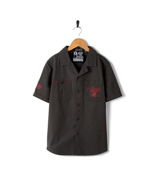 A dark grey Kingpin Krew - Kids Short Sleeve Shirt with a red Saltrock logo on it.