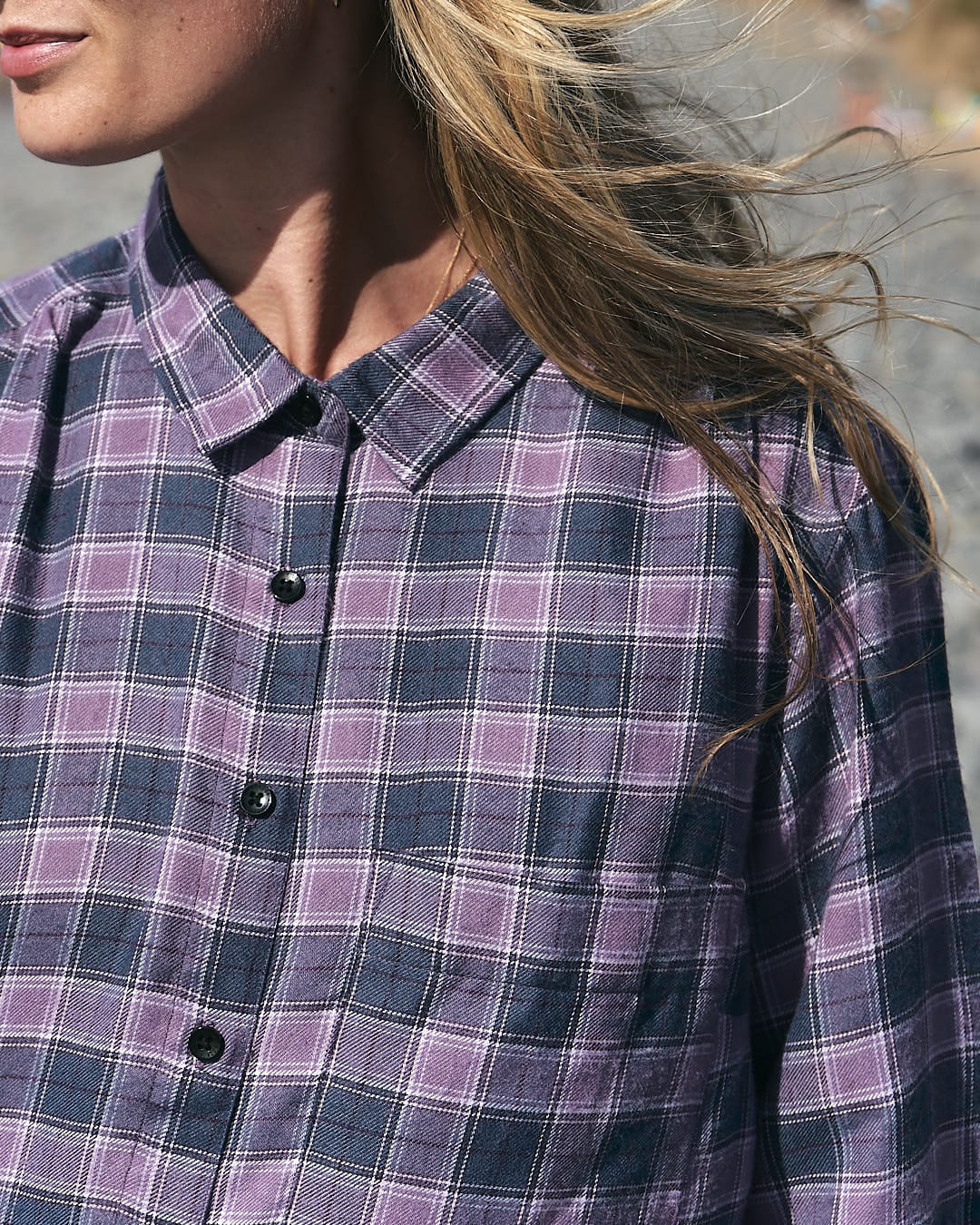 A woman wearing a Kizzie - Saltrock Womens Check Boyfriend Shirt - Purple on the beach.