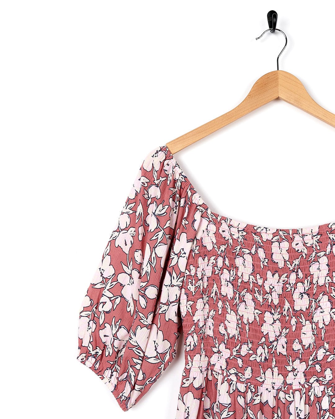 A Larran - Womens Shirred Dress - Mid Pink by Saltrock, a pink and white floral dress, hanging on a hanger.