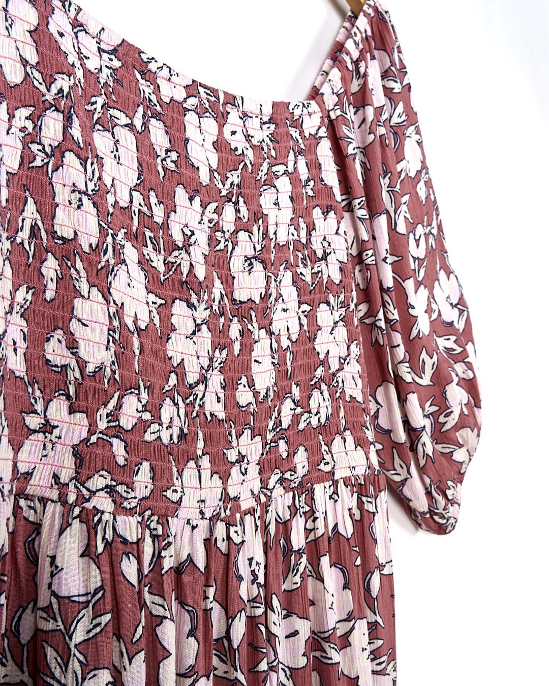 A Saltrock Larran - Womens Shirred Dress - Mid Pink hanging on a hanger.