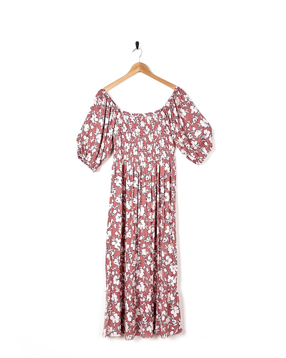 A Larran - Womens Shirred Dress - Mid Pink by Saltrock hanging on a hanger.