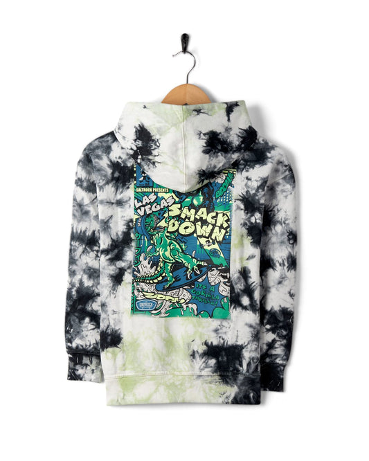 A black and white tie-dye Saltrock Las Vegas Smackdown - Kids Glow in the Dark Oversized Pop Hoodie - Multi on a hanger, featuring glow in the dark graphics with text that reads "Taco Sandy Heroes Presents Taco Smack Down" on the back.