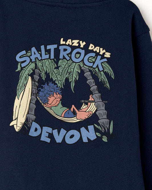 Graphic on a Lazy Location Wales - Recycled Kids Hoodie - Blue showing a person relaxing in a hammock under palm trees with the text "lazy days Saltrock Wales.