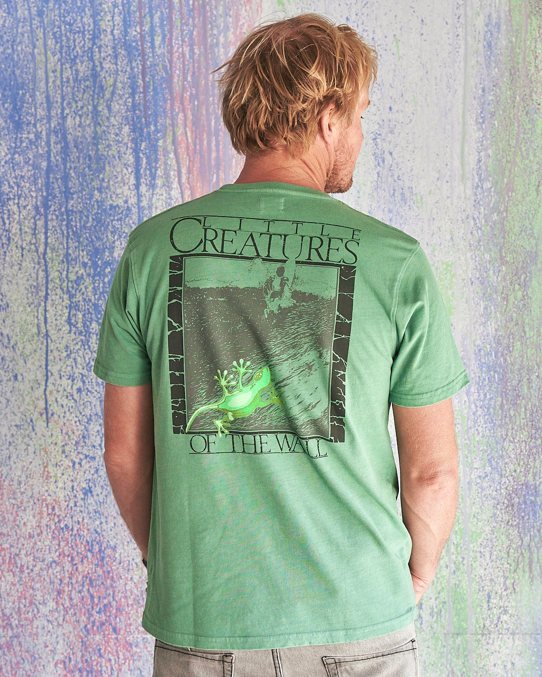 The back of a man wearing a Saltrock Little Creatures - Limited Edition 35 Years T-Shirt that says great trees of the world.