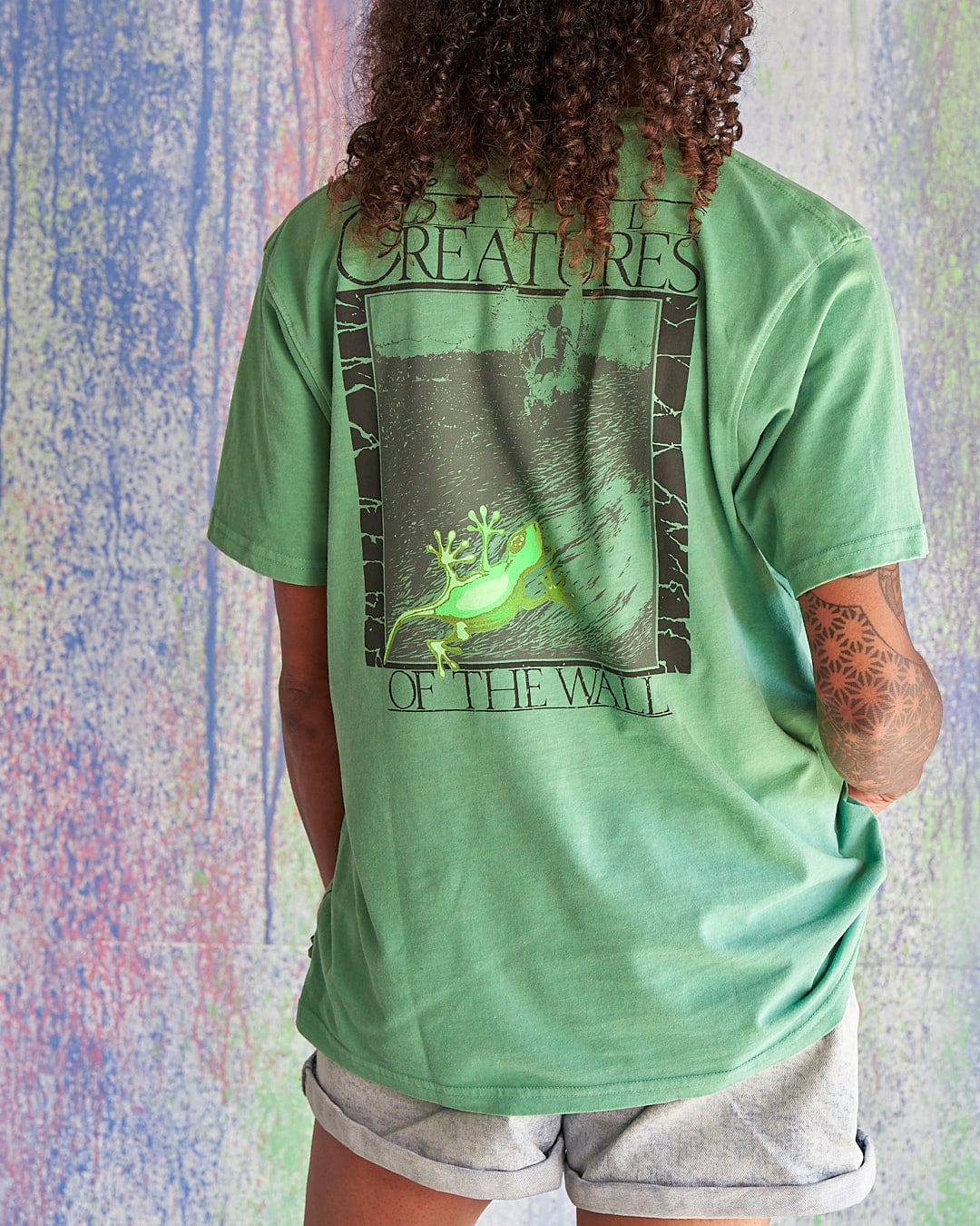 The back of a woman wearing a Saltrock Little Creatures - Limited Edition 35 Years T-Shirt.