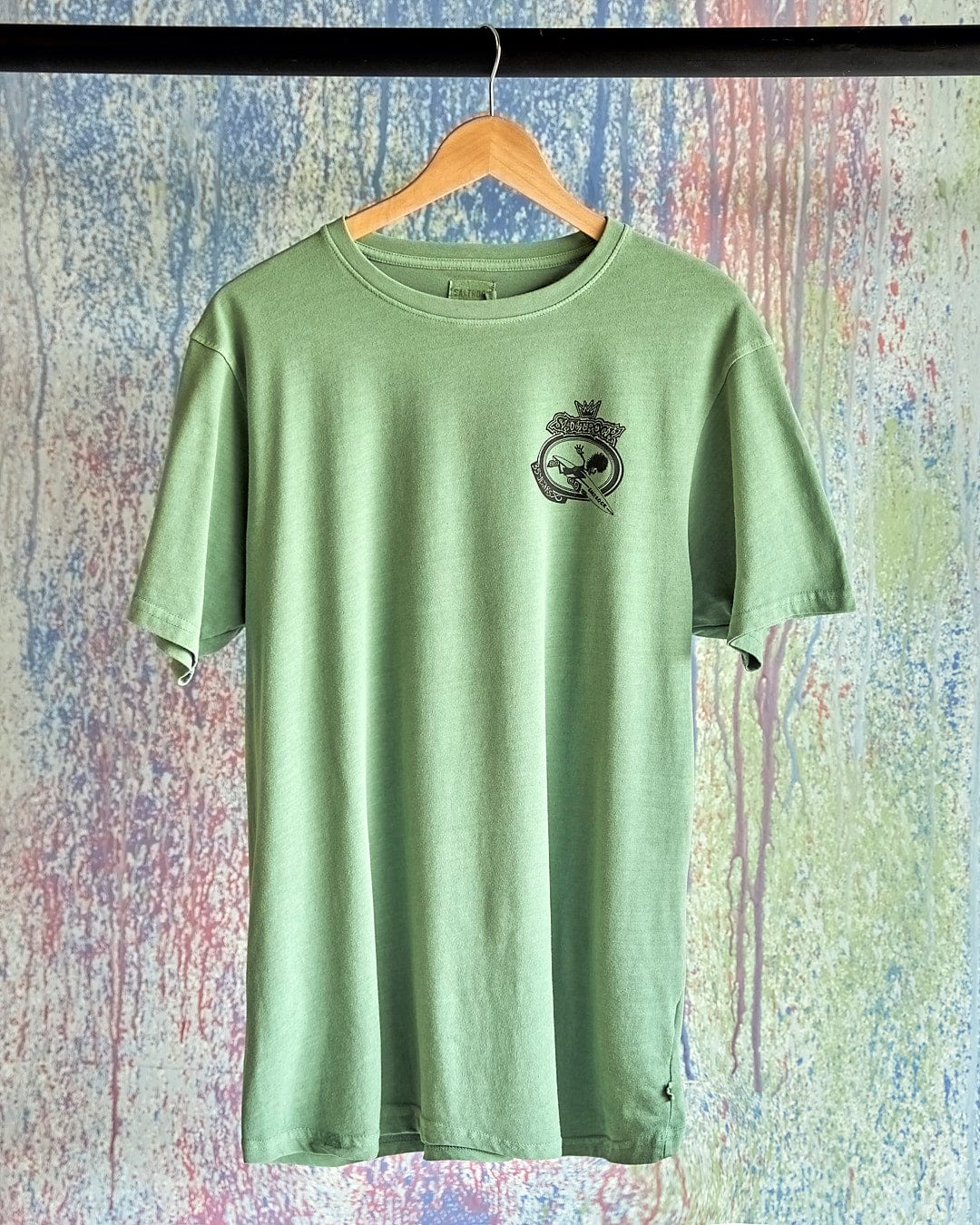 A Little Creatures - Limited Edition 35 Years T-Shirt by Saltrock hanging on a wall.