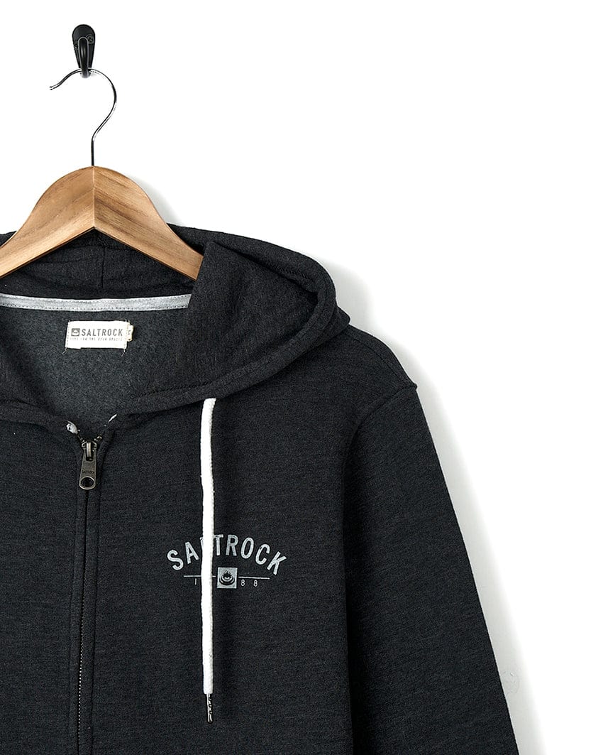 A Location Zip Hoodie - Croyde - Dark Grey with the brand name Saltrock on it.