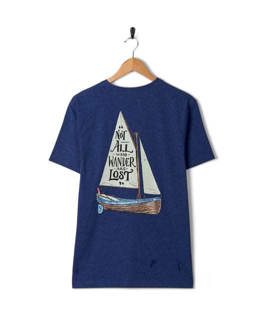 A blue Lost Ships - Mens Short Sleeve T-Shirt by Saltrock with a sailboat graphic and the quote "not all who wander are lost" hanging on a wall-mounted hanger.