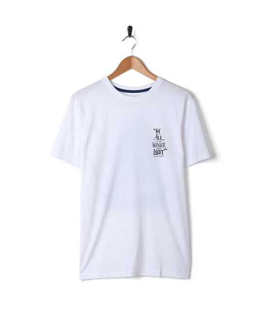 A plain white Saltrock Lost Ships Short Sleeve T-Shirt with the text "y'all mind if i never exist" printed on the front, hanging on a wall-mounted coat hanger.
