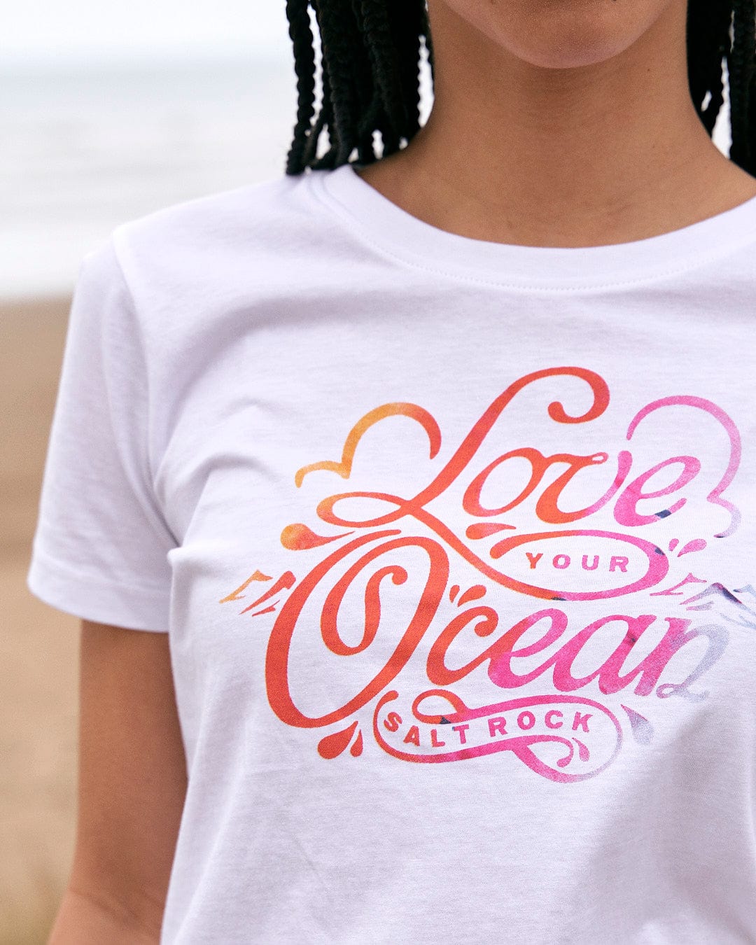A woman wearing a Saltrock Love Your Ocean - Womens Short Sleeve T-Shirt - White.