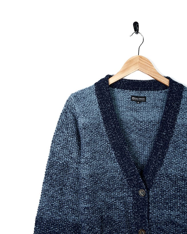 A Saltrock Lynton - Womens Button Cardigan - Dark Blue sweater in a blue and black ombre pattern on a hanger.