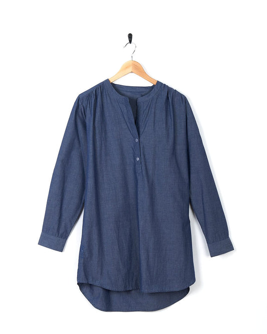 A Manina - Womens Beach Shirt - Blue hanging on a hanger.