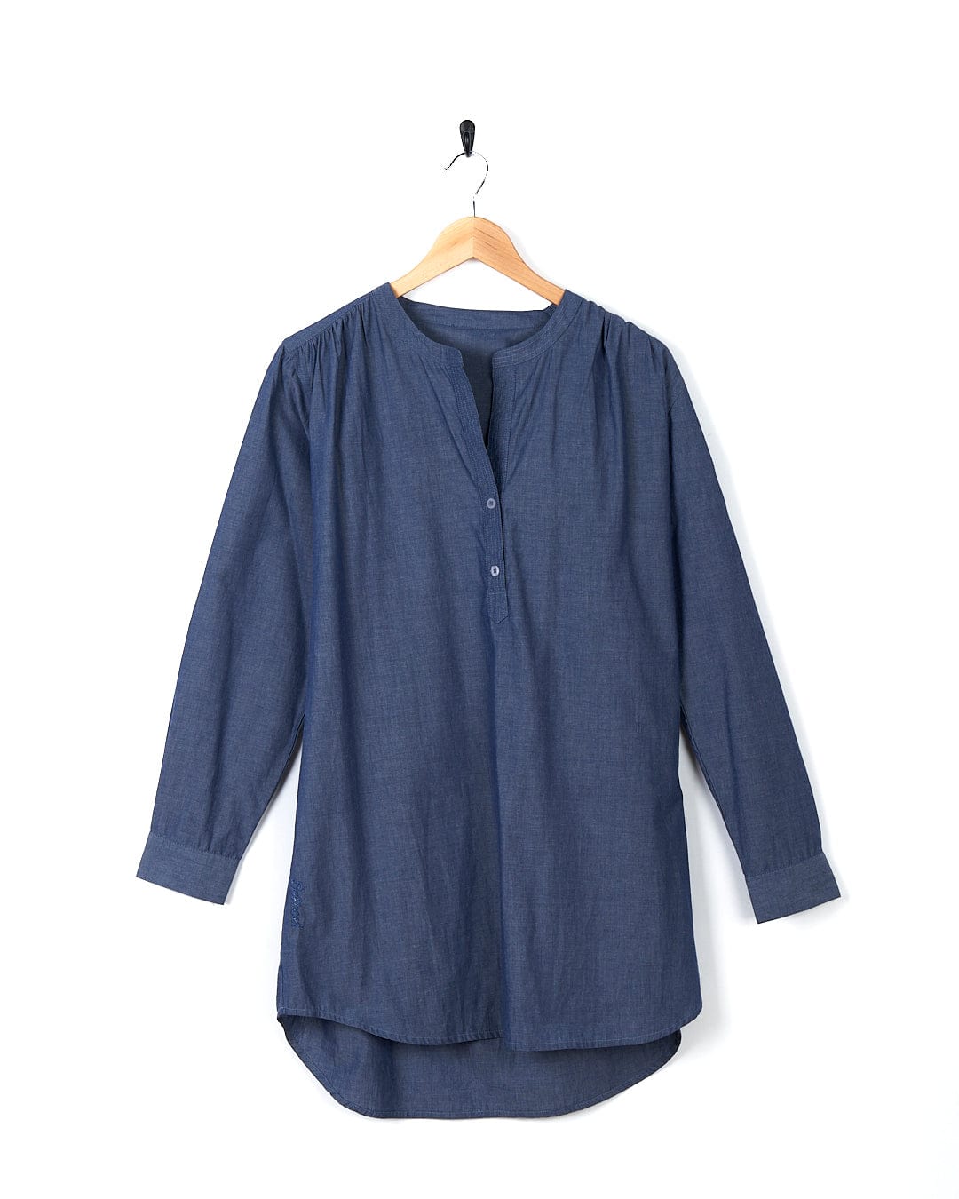 A Manina - Womens Beach Shirt - Blue hanging on a hanger.