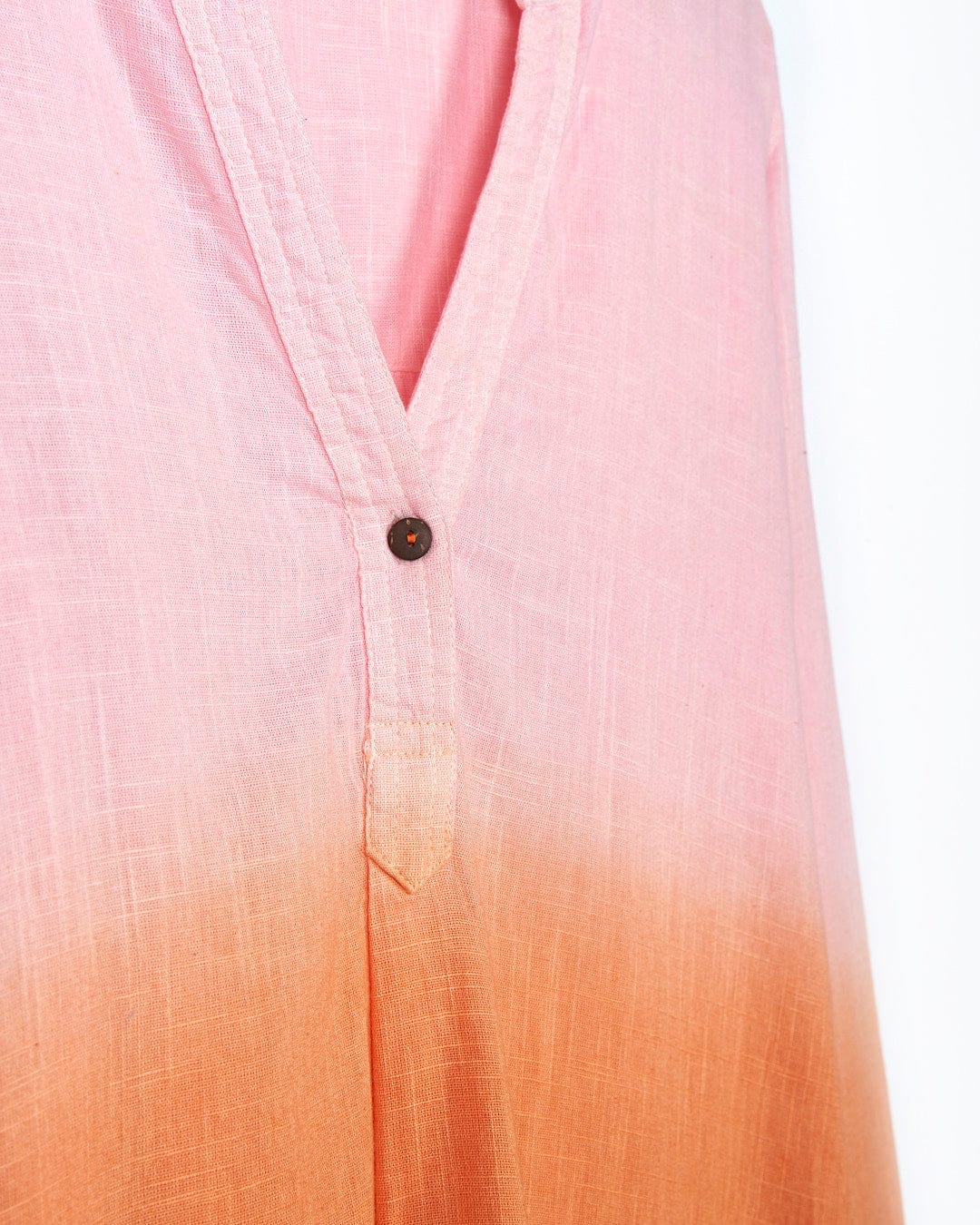 A Manina - Womens Dip Die Beach Shirt - Orange Saltrock blouse hanging on a hanger.