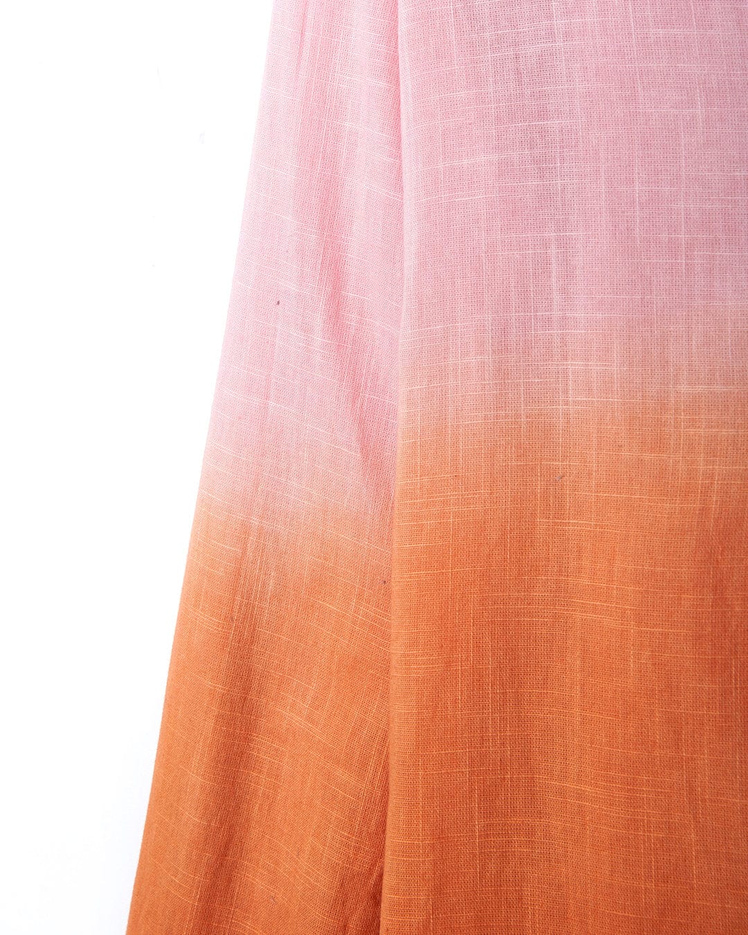 A Manina - Womens Dip Die Beach Shirt - Orange by Saltrock hanging on a white wall.