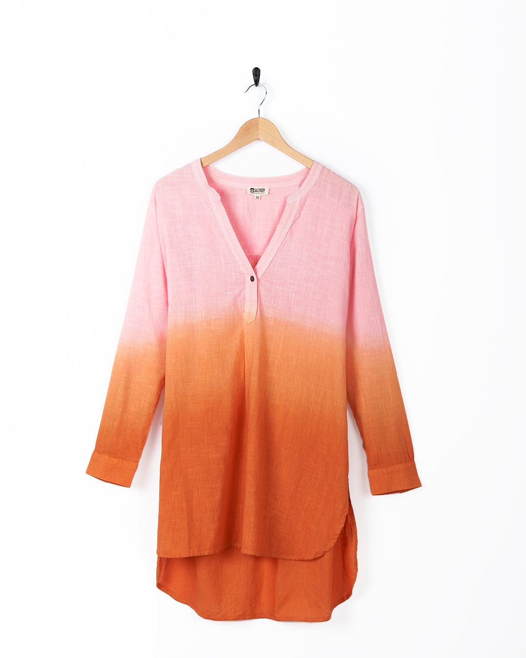 A Saltrock Manina - Womens Dip Die Beach Shirt - Orange tunic hanging on a hanger.