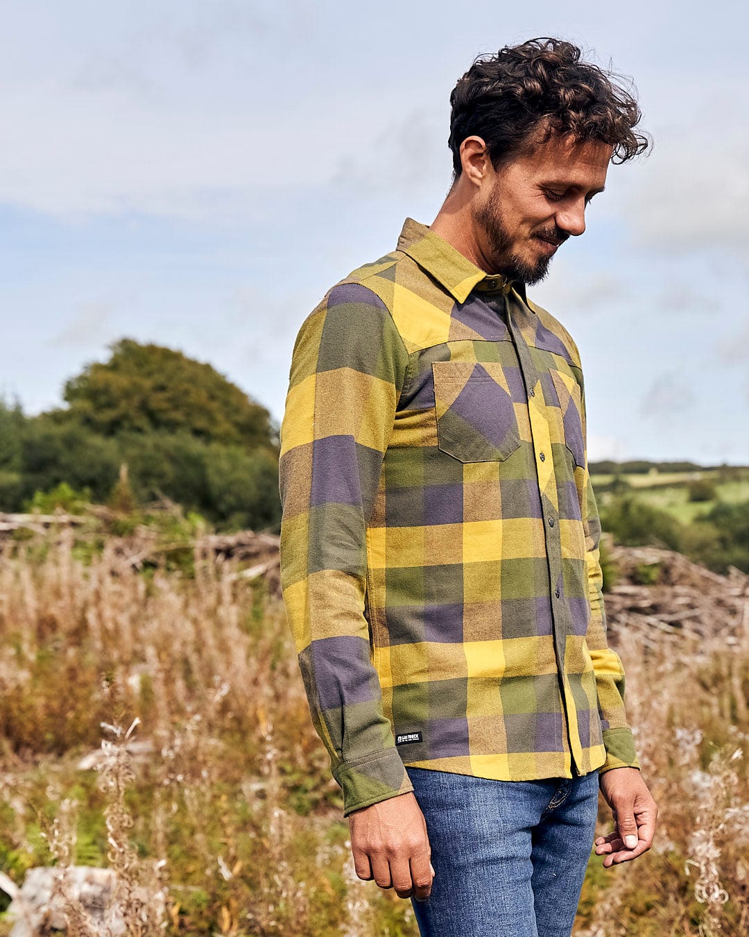 A man in a Saltrock Mattie - Mens Long Sleeve Shirt - Yellow standing in a field.