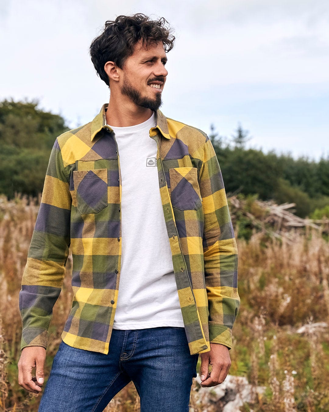 A man in a Saltrock Mattie - Mens Long Sleeve Shirt - Yellow standing in a field.