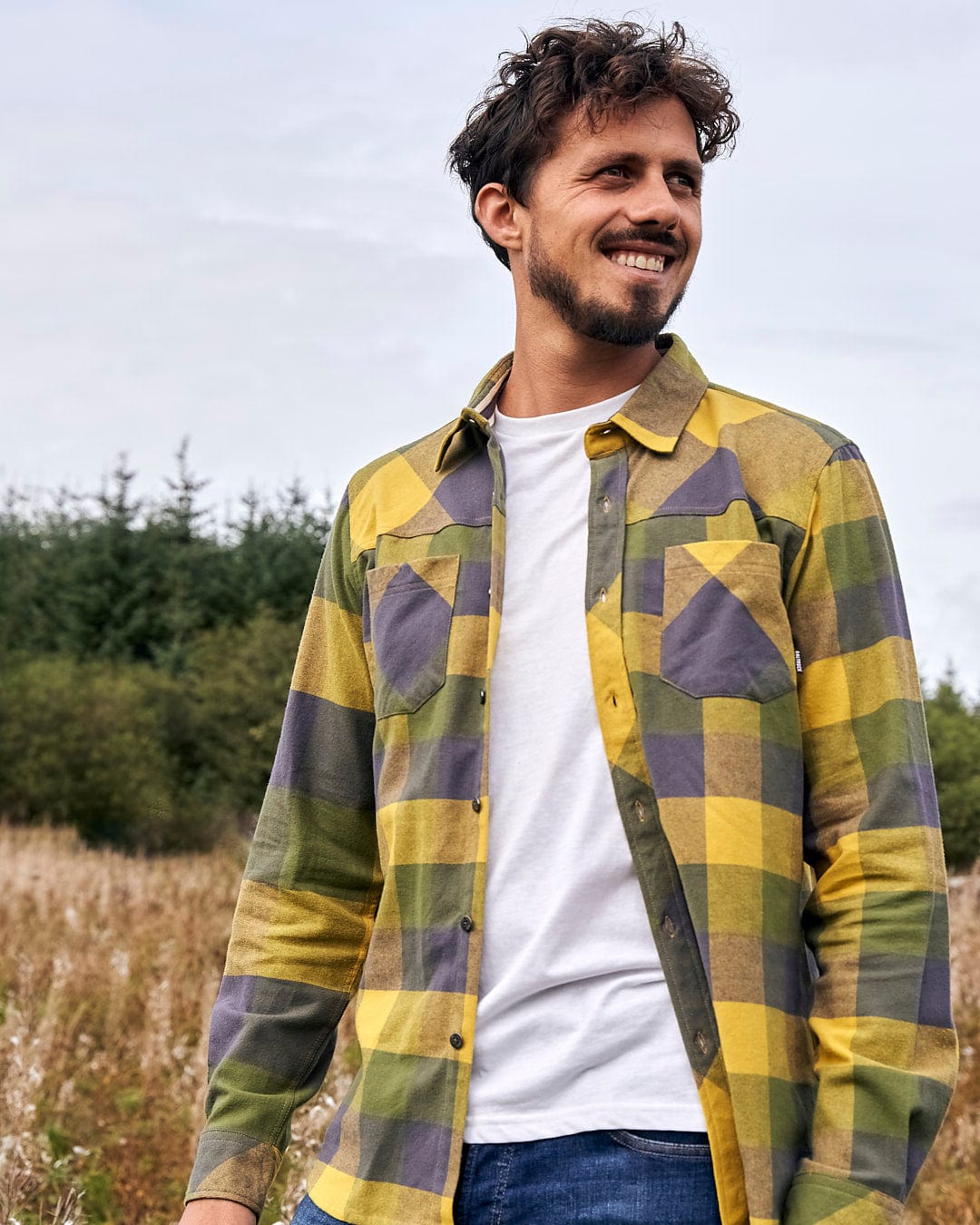 A man wearing a Saltrock Mattie - Mens Long Sleeve Shirt - Yellow in a field.
