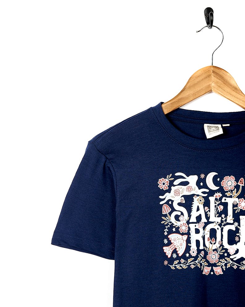A kids navy t-shirt with a floral Meadow design and Saltrock branding.
