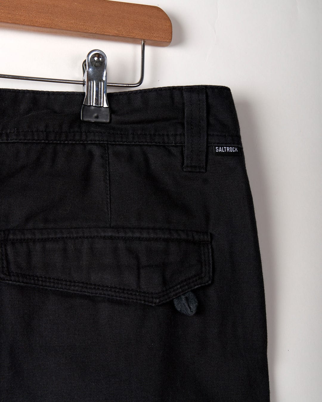 Close-up of the back pocket and waistband of Saltrock's Meltan Men's Straight Leg Twill Trouser in dark grey, featuring a brand label near the belt loop.