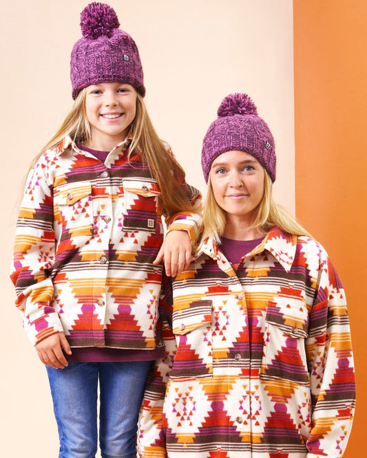 A mother and daughter wearing Saltrock's Dallyn - Kids Aztec Fleece Shacket in Orange.