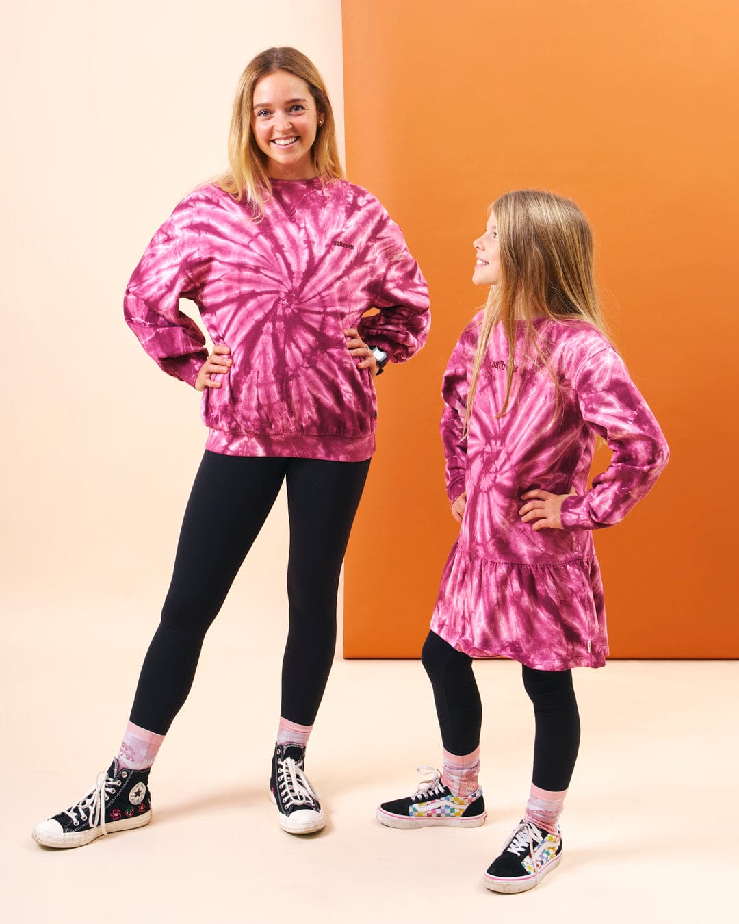 A mother and daughter showcasing Saltrock branding in their fashionable Dawn - Womens Tie Dye Sweatshirt - Pink.