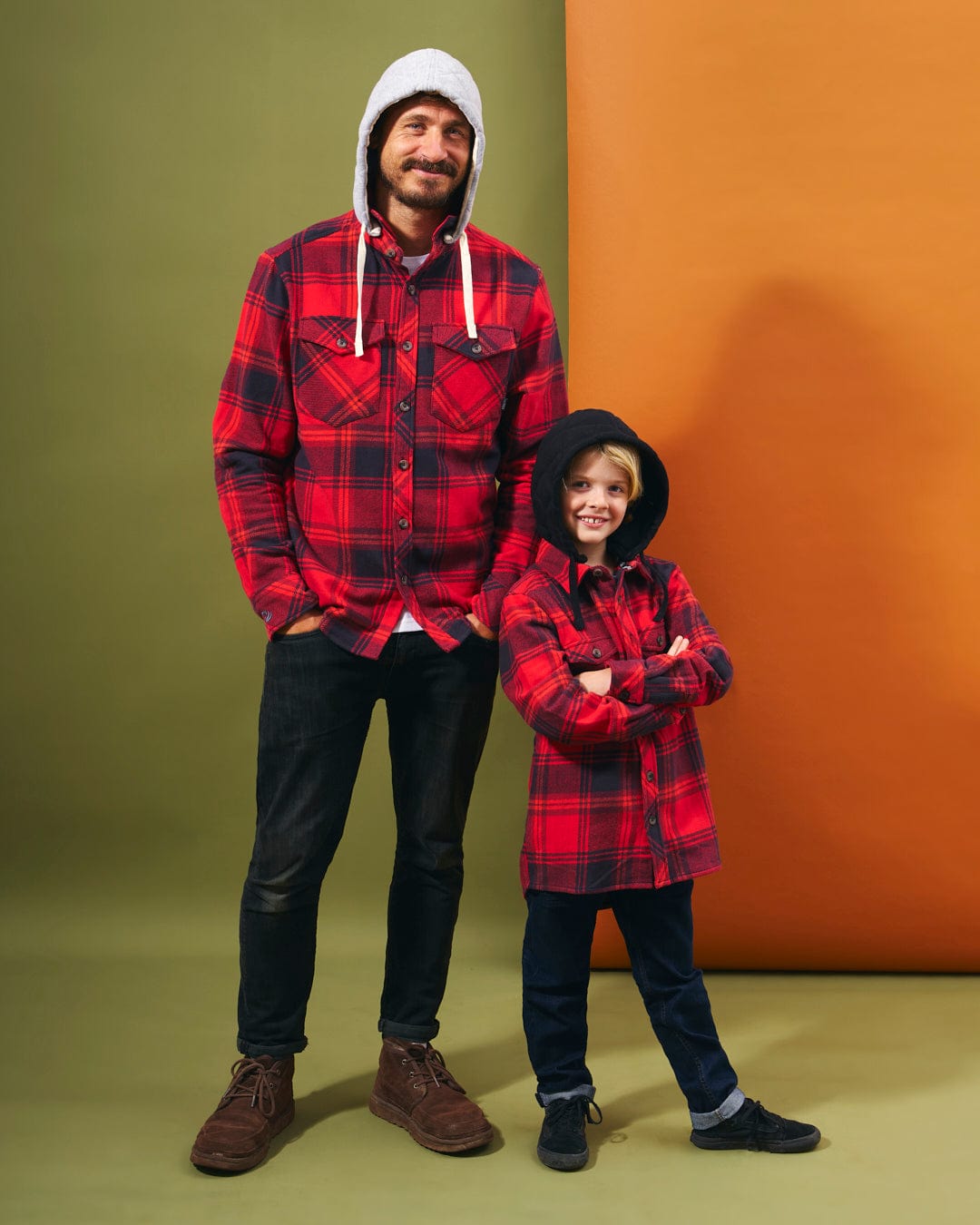 A man and a boy wearing Saltrock's Hawkins - Hooded Long Sleeve Check Shirt in Red made of durable cotton fabric.