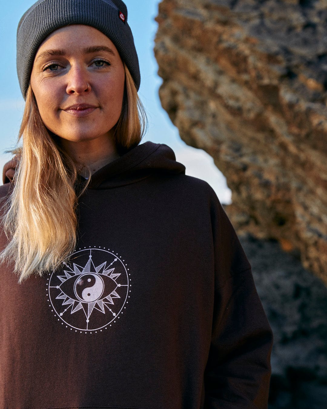 A woman displaying her style and comfort in a Saltrock Mocha - Womens Pop Hoodie - Brown.