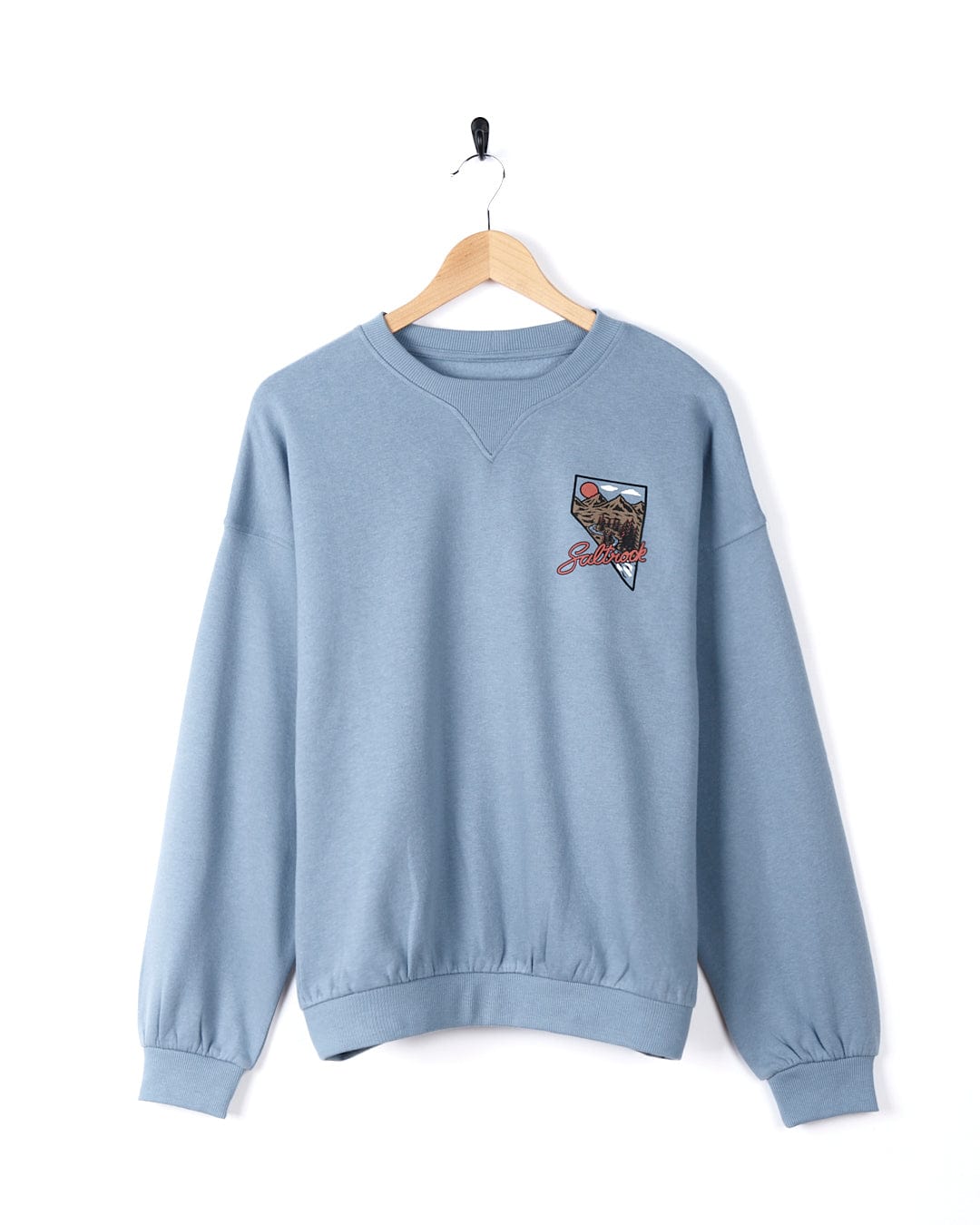 A blue Saltrock Mountain Creek Almira - Womens Balloon Sleeve Sweat - Blue sweatshirt with an image of a train, perfect for everyday wear.