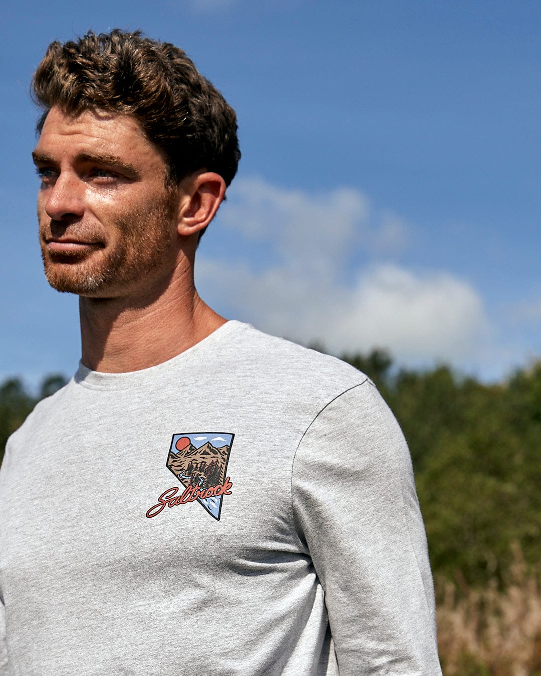A man wearing a Saltrock - Mountain Creek Mens Long Sleeve T-Shirt in Grey.