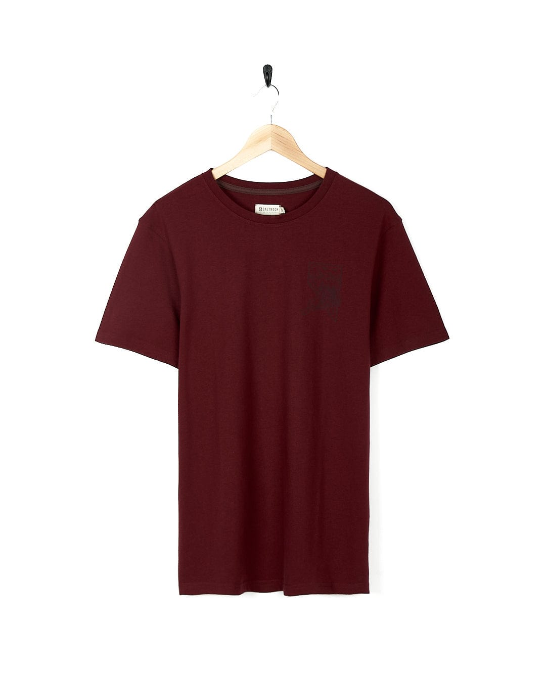 A maroon Saltrock Mountain Creek Mens Short Sleeve T-Shirt hanging on a wooden hanger.