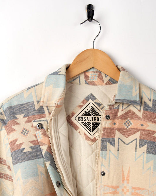 Mylene - Aztec Shacket - Cream jacket with a Saltrock label hanging on a wooden hanger against a white background.